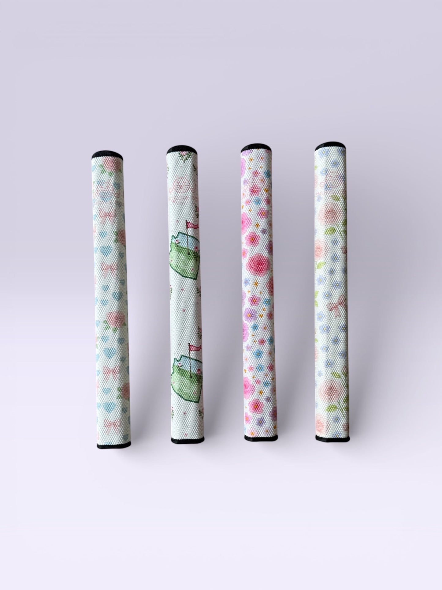 Snuggle Bug Golf Starlight Bloom putter grips featuring lavender roses, daisies, and gold stars on a white EVA core.
