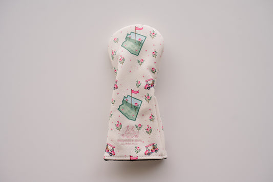 Floral patterned golf club head cover on a gray background