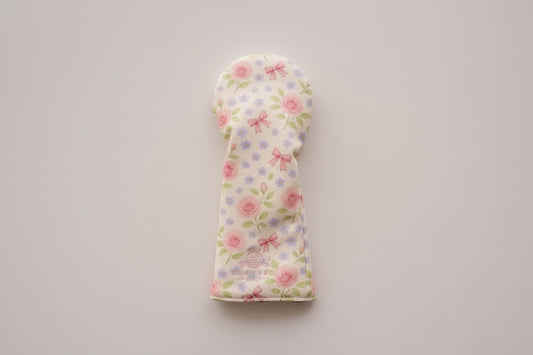 Floral patterned golf club head cover on a light gray background