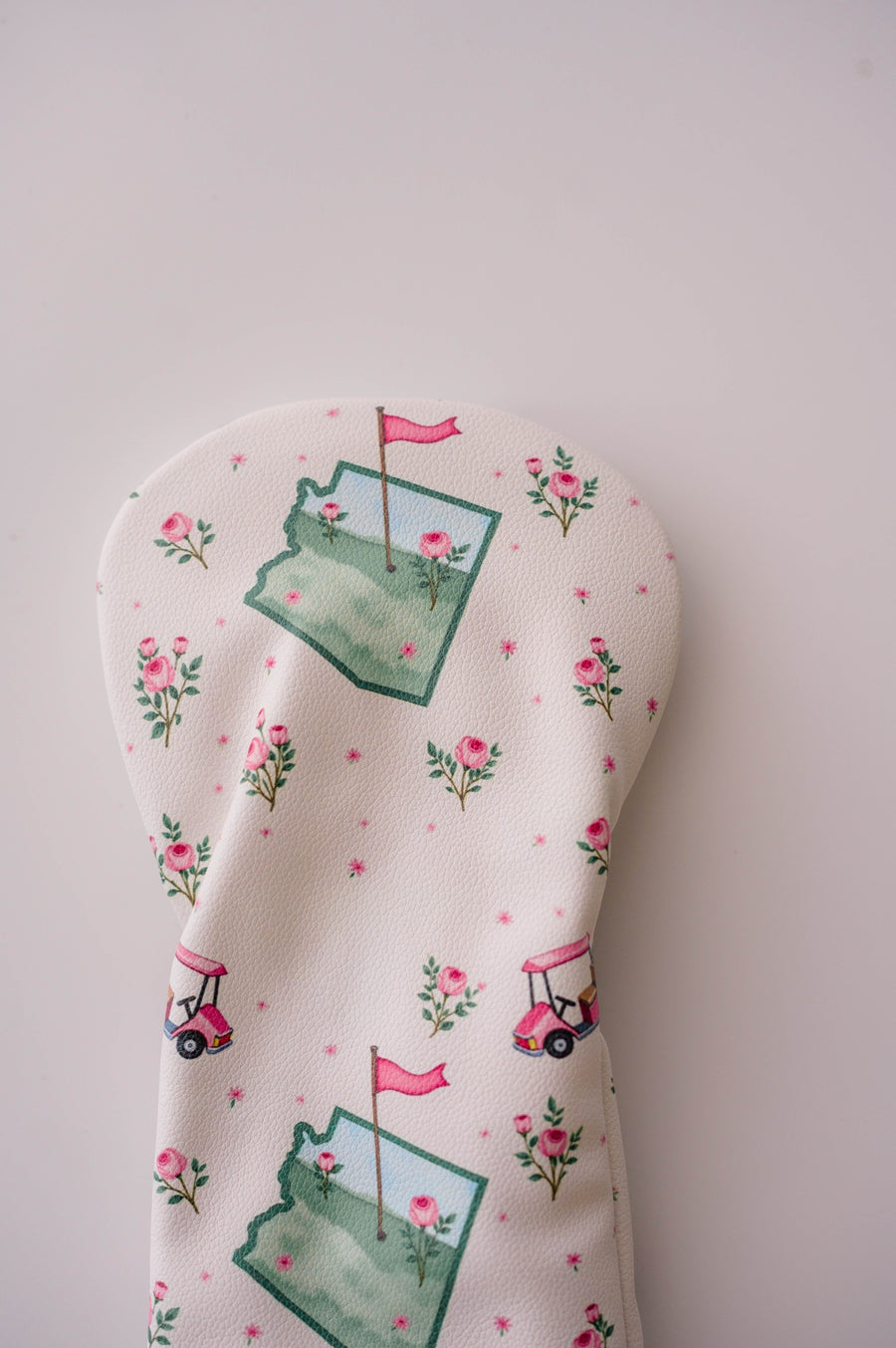 Snuggle Bug Golf Arizona Bloom driver headcover in cream eco-leather with pink golf carts and rose floral print.