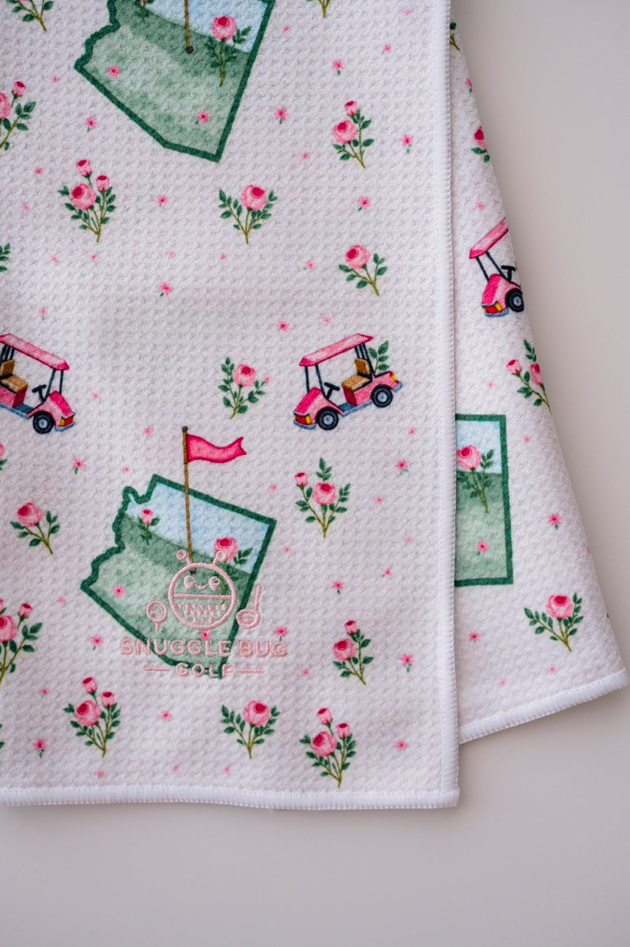 Snuggle Bug Golf Arizona Bloom waffle microfiber towel with pink roses, golf carts, and desert blush pattern.