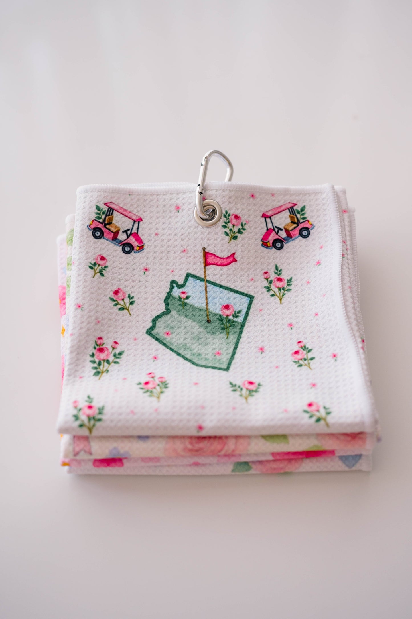 Snuggle Bug Golf Arizona Bloom waffle microfiber towel with pink golf carts, roses, and desert blush pattern.