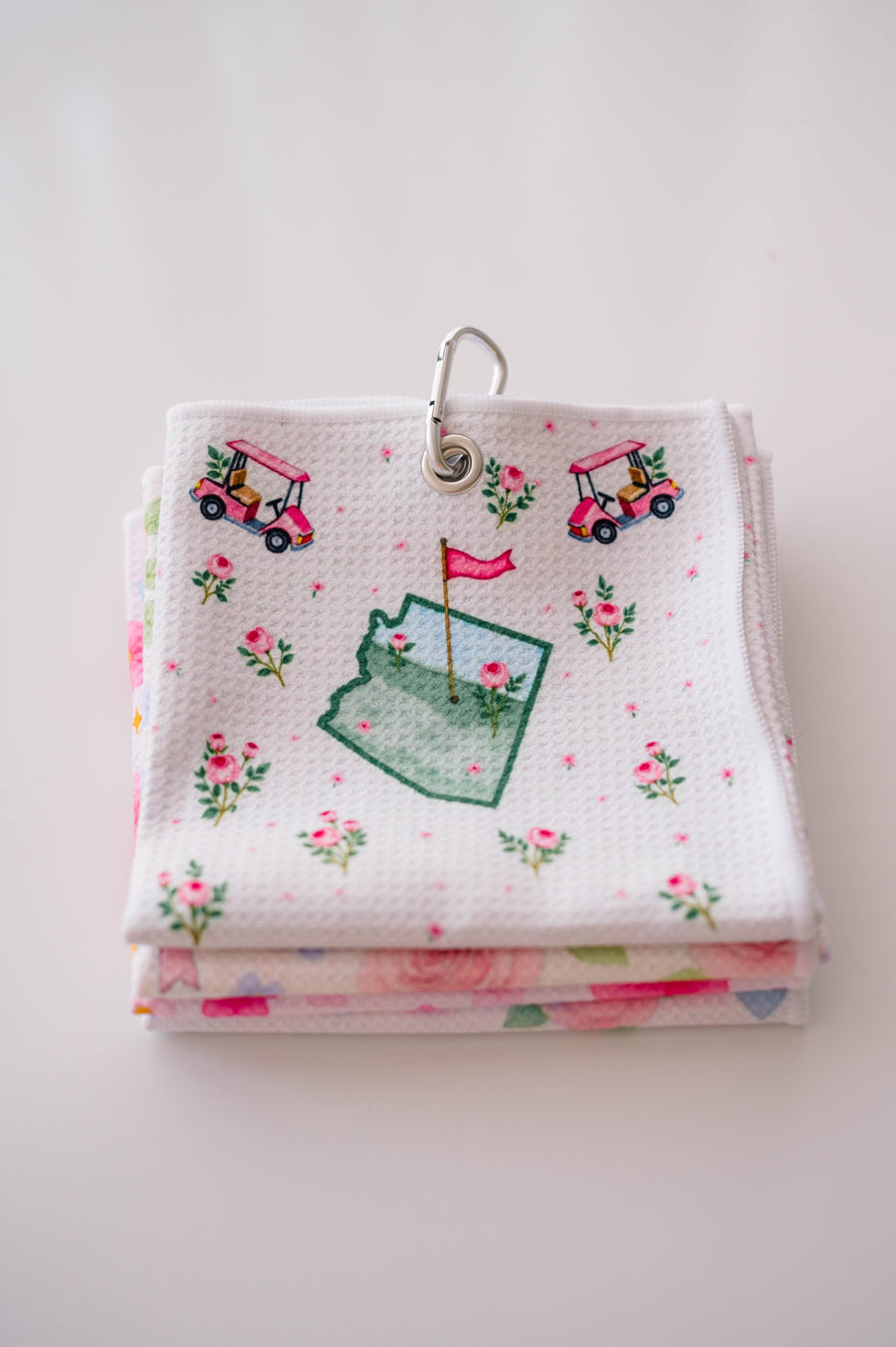 Snuggle Bug Golf Arizona Bloom waffle microfiber towel with pink golf carts, roses, and desert blush pattern.