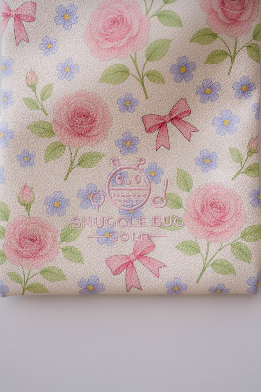 Snuggle Bug Golf drawstring pouch in cream eco-leather with pink roses, blue flowers, and pink ribbon print.