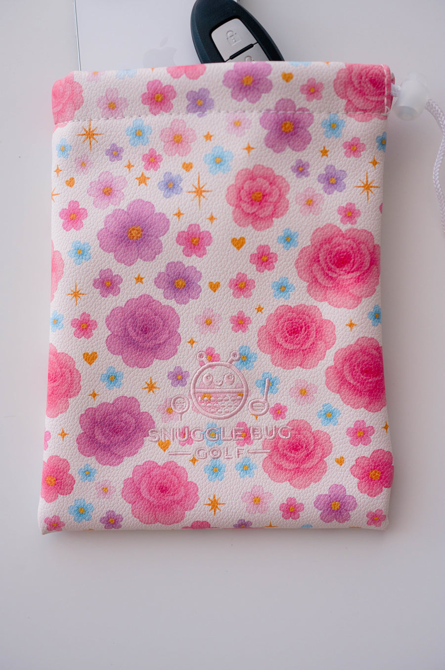 Snuggle Bug Golf Starlight Bloom drawstring pouch in pink floral eco-leather with white drawstring closure.