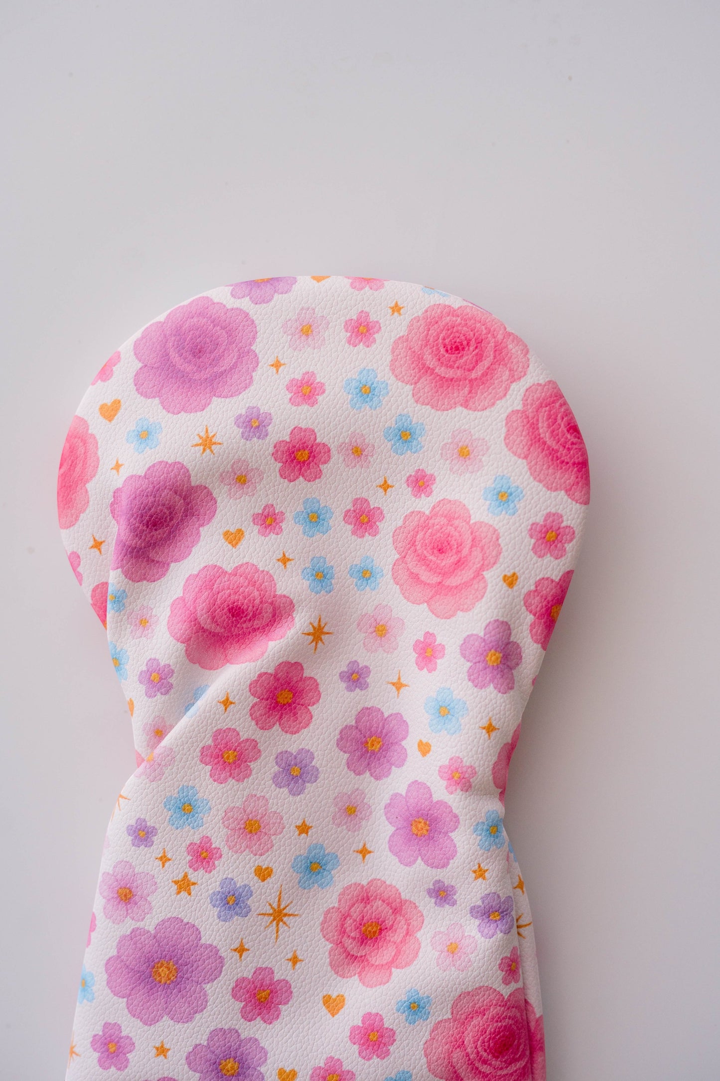 Snuggle Bug Golf Starlight Bloom driver head cover with pink floral, lavender daisy, and golden star print pattern.