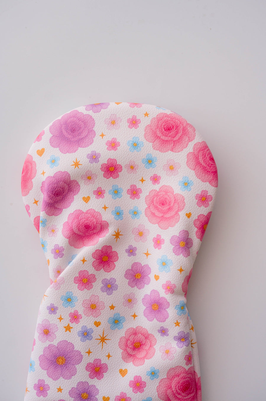 Snuggle Bug Golf Starlight Bloom driver head cover with pink floral, lavender daisy, and golden star print pattern.