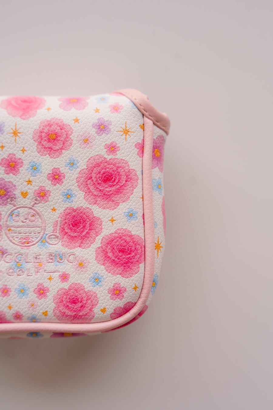 Snuggle Bug Golf mallet putter headcover featuring a white textured eco-leather with pink floral and gold star print.