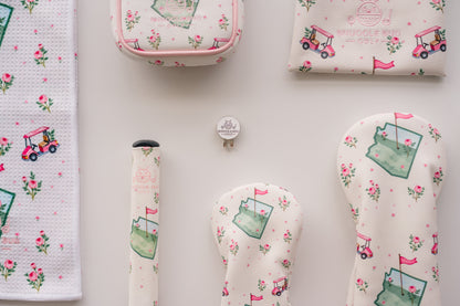 Snuggle Bug Golf hat clip and ball marker set with signature floral golf cart design on a white background