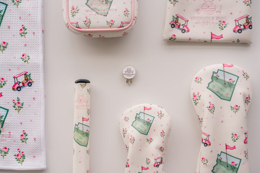 Snuggle Bug Golf hat clip and ball marker set with signature floral golf cart design on a white background