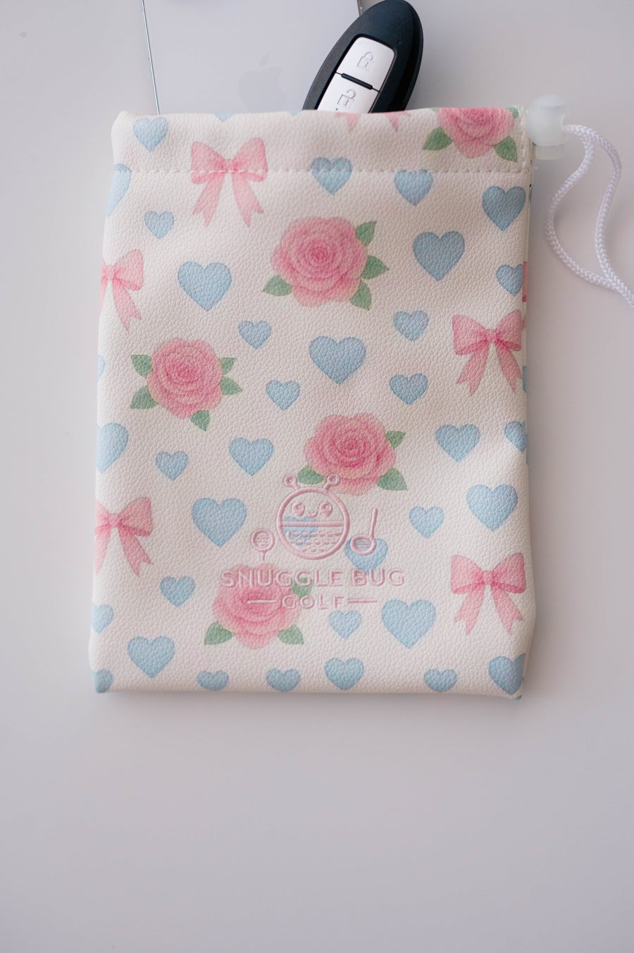Snuggle Bug Golf drawstring pouch in blush eco-leather with pink roses, blue hearts, and bows pattern.