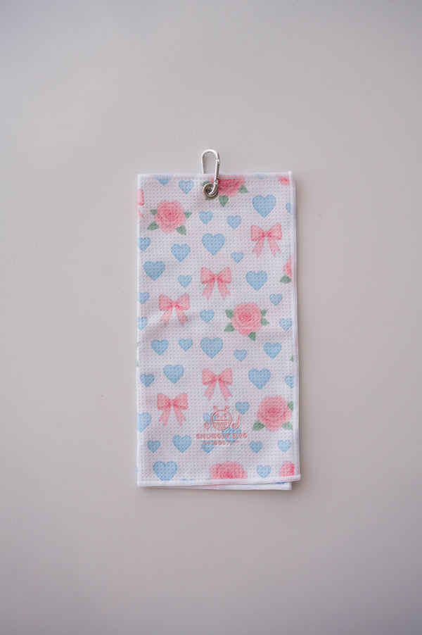 Snuggle Bug Golf microfiber waffle towel with pink roses, baby blue hearts, and blush bows with a silver hook.
