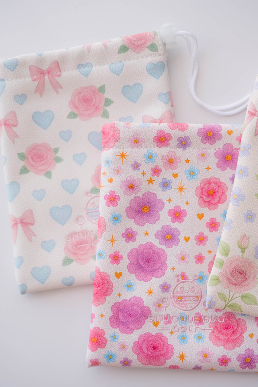 Snuggle Bug Golf Starlight Bloom drawstring pouch in textured eco-leather with pink floral and heart print.
