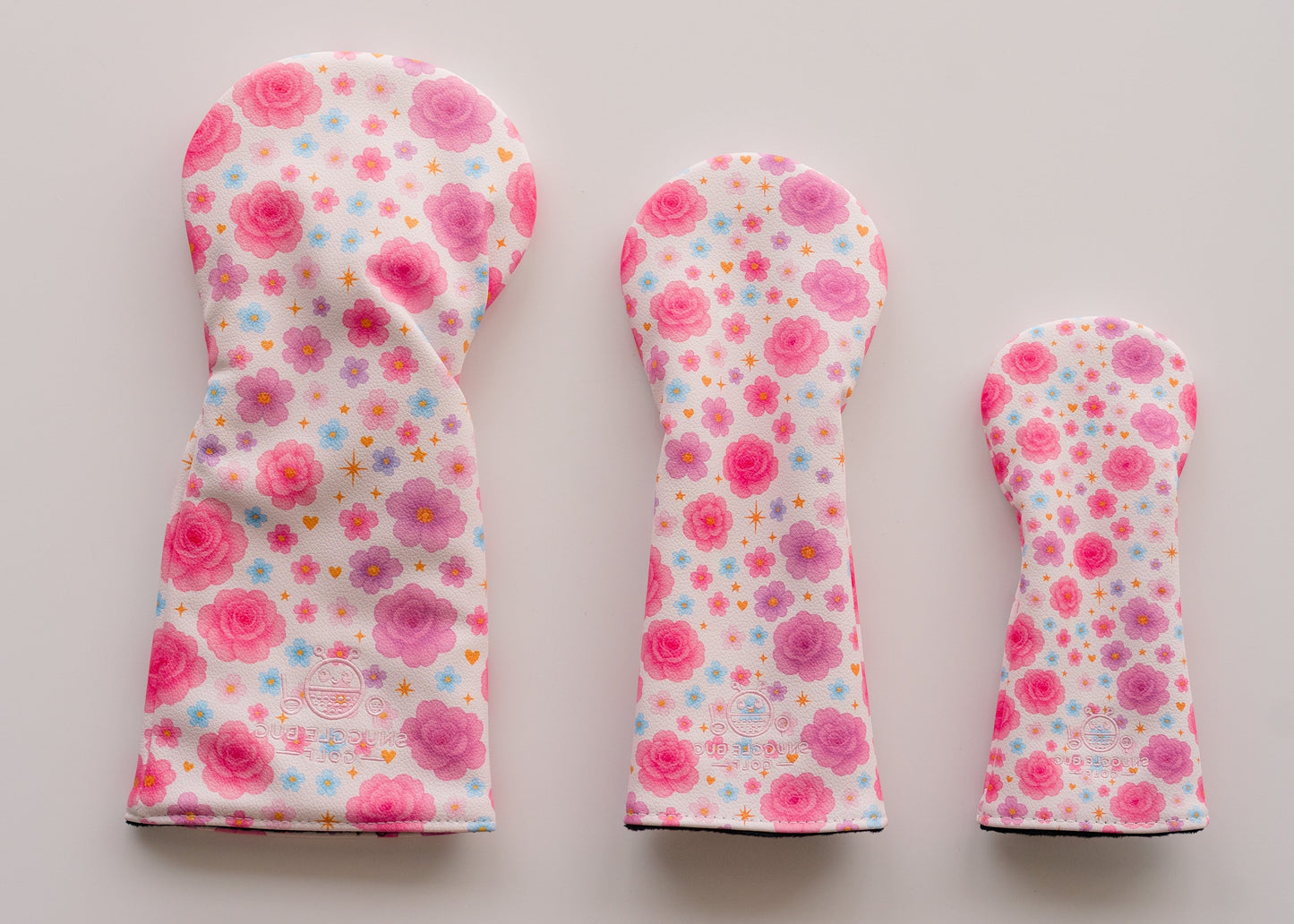 Snuggle Bug Golf Starlight Bloom fairway headcovers in pink and lavender floral print with gold stars on eco-leather.