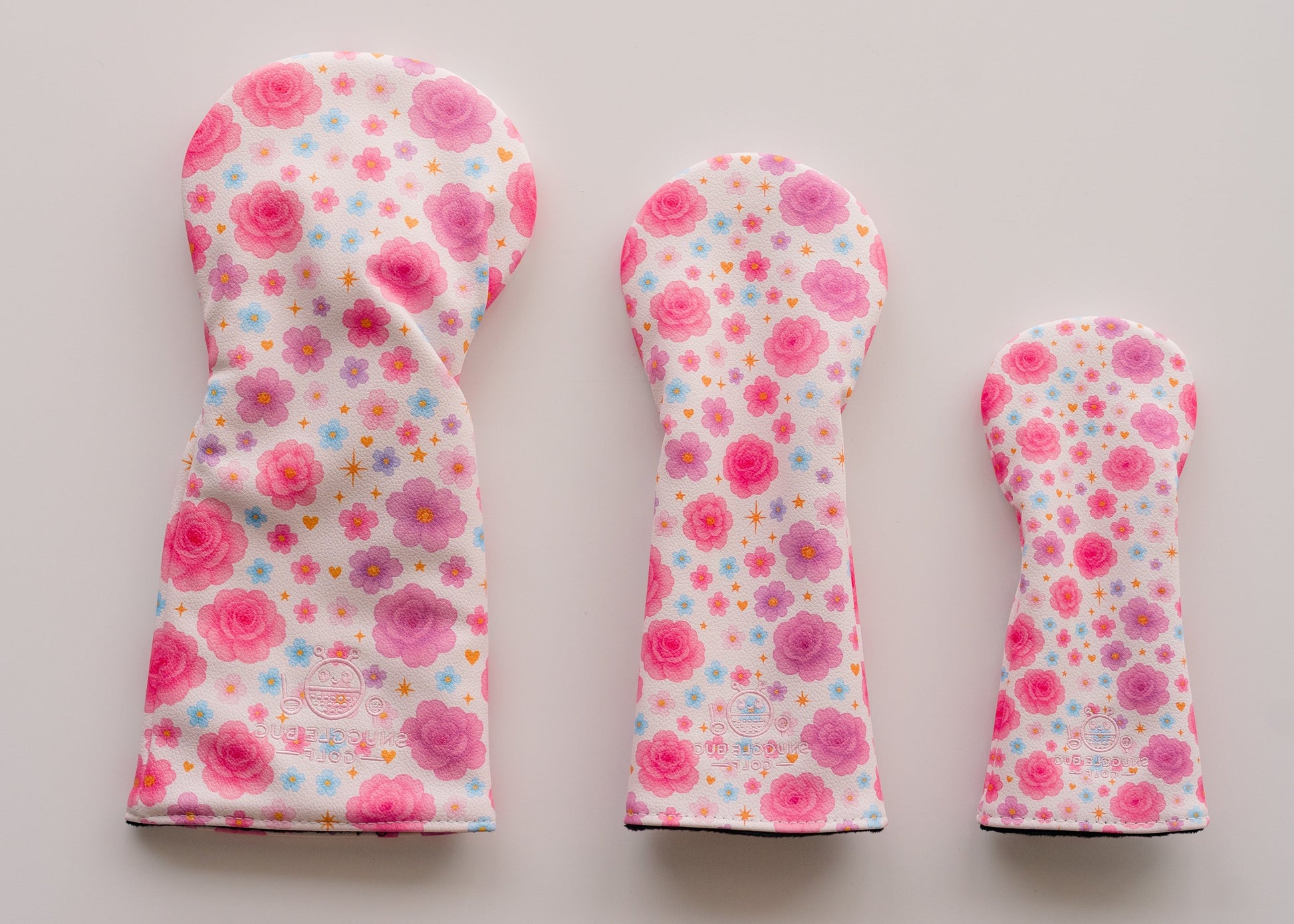 Snuggle Bug Golf Starlight Bloom fairway headcovers in pink and lavender floral print with gold stars on eco-leather.