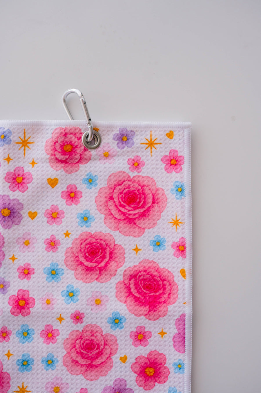 Snuggle Bug Golf Starlight Bloom waffle microfiber towel featuring pink roses, lavender flowers, and golden stars.