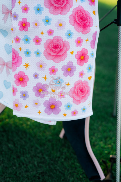 Snuggle Bug Golf Starlight Bloom waffle microfiber towel with pink roses, lavender flowers, and gold stars.
