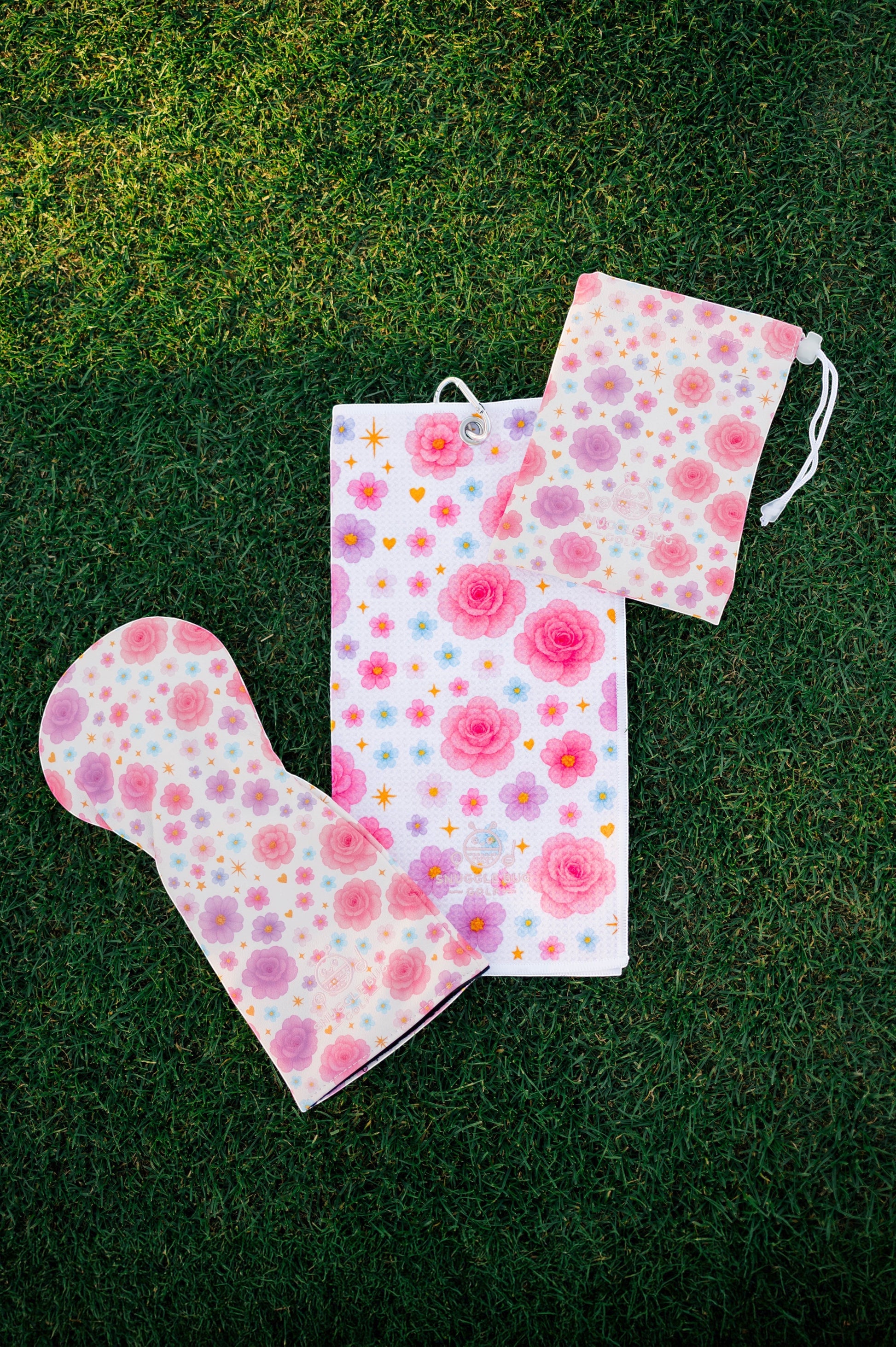 Snuggle Bug Golf Starlight Bloom driver head cover, golf towel, and pouch set with pink floral and star pattern.