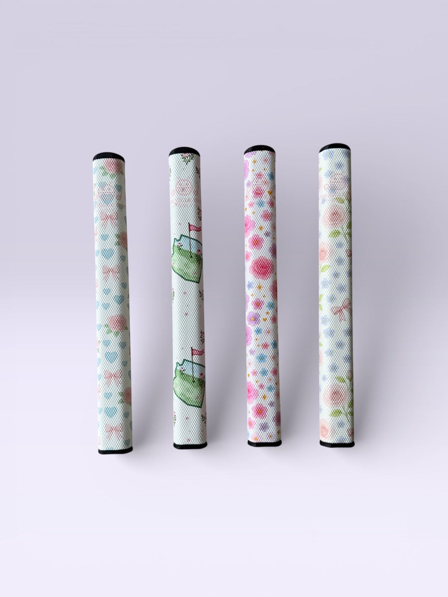 Snuggle Bug Golf Starlight Bloom putter grips featuring lavender roses, daisies, and gold stars on a white EVA core.