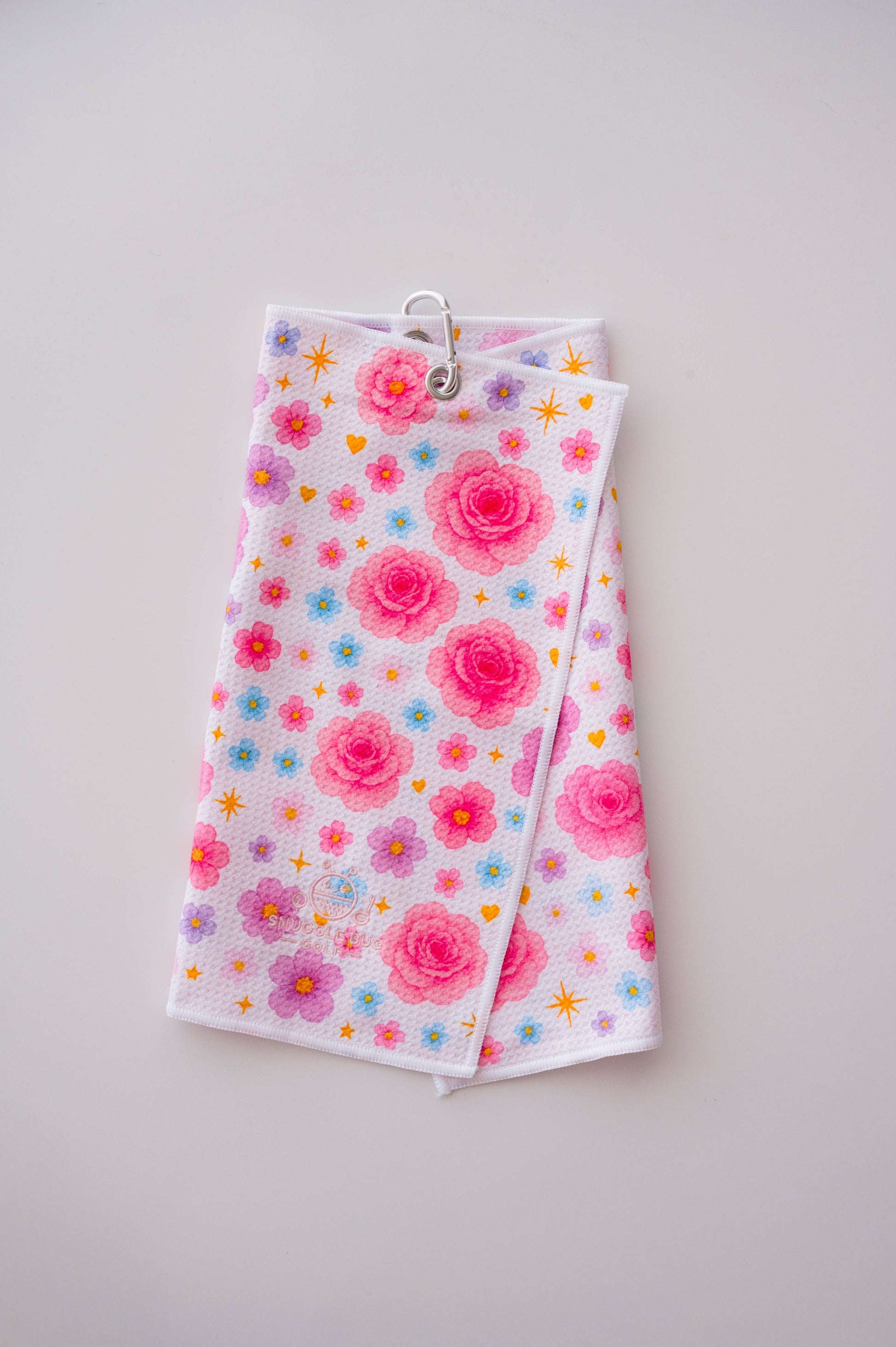 Snuggle Bug Golf Starlight Bloom waffle microfiber towel with pink roses, lavender flowers, and gold stars.