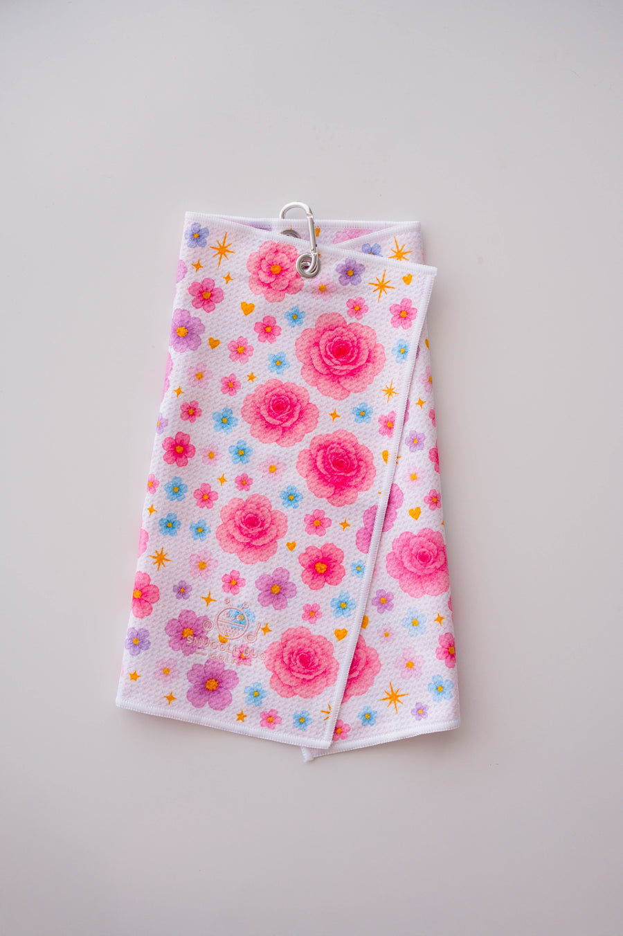 Snuggle Bug Golf Starlight Bloom waffle microfiber towel with pink roses, lavender flowers, and gold stars.