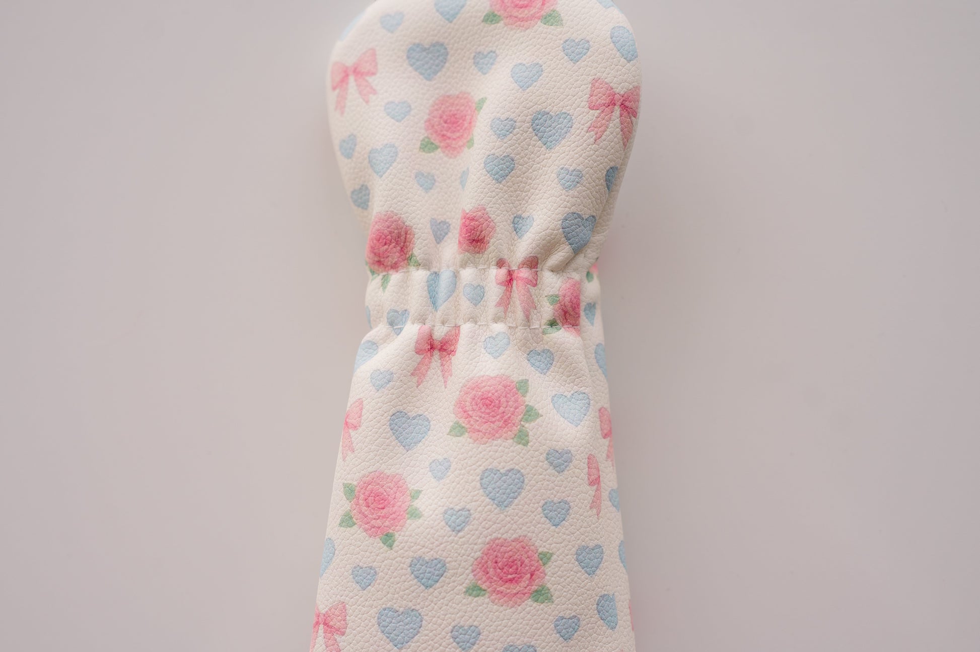 Snuggle Bug Golf fairway headcover in cream eco-leather with pink roses, lavender hearts, and blush bow print.
