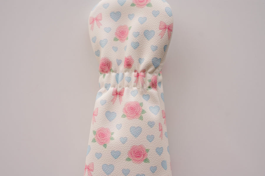 Snuggle Bug Golf fairway headcover in cream eco-leather with pink roses, lavender hearts, and blush bow print.