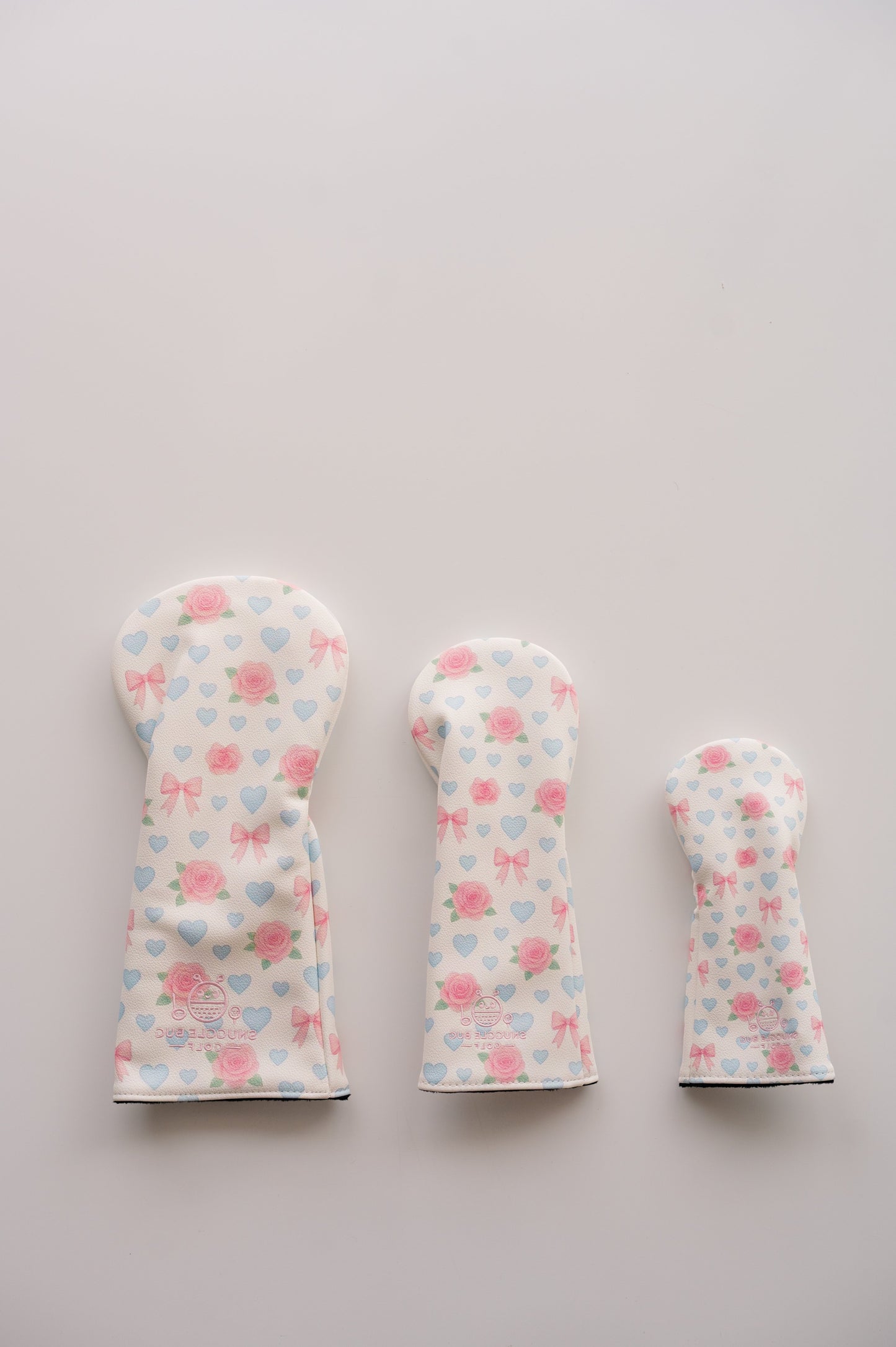 Snuggle Bug Golf Sweetheart Rose fairway headcovers in three sizes with pink roses, lavender hearts, and blush bows.