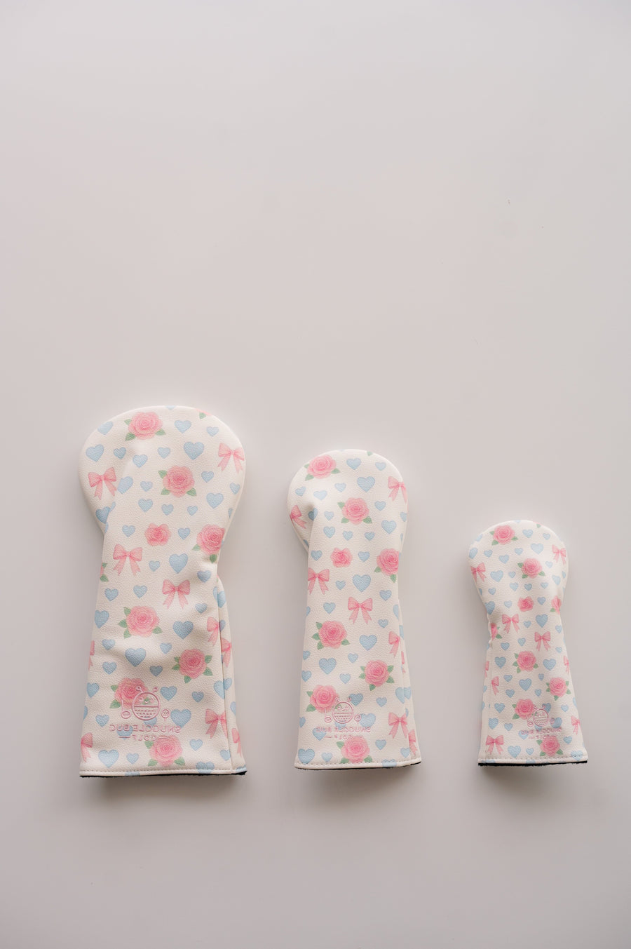 Snuggle Bug Golf Sweetheart Rose fairway headcovers in three sizes with pink roses, lavender hearts, and blush bows.