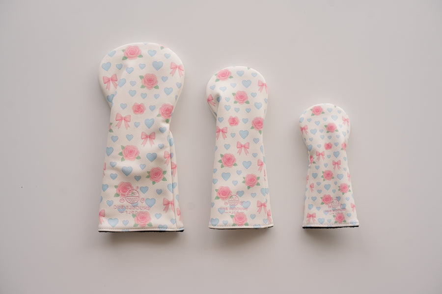 Snuggle Bug Golf Sweetheart Rose hybrid headcovers in three sizes with pink roses, blue hearts, and blush bows.