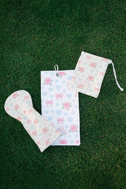 Snuggle Bug Golf Sweetheart Rose drawstring pouch with matching golf towel and club cover on green grass