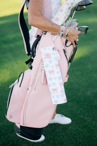 Snuggle Bug Golf Sweetheart Rose microfiber towel with pink roses and blue hearts clipped to a pink golf bag