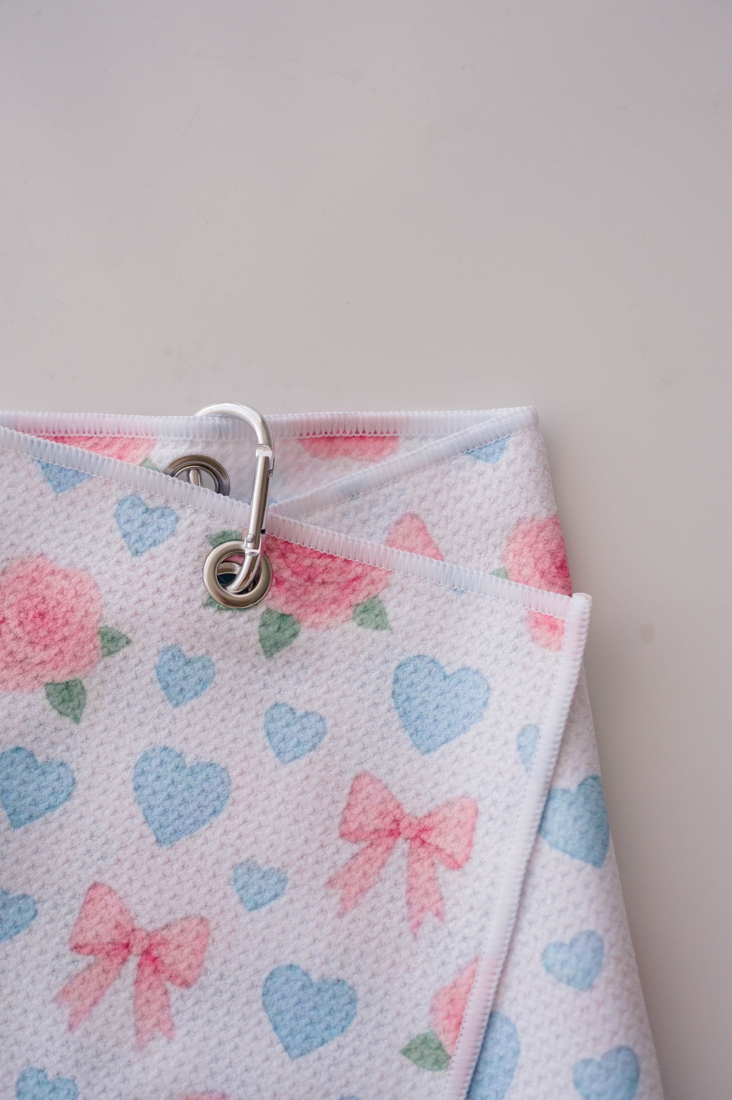 Snuggle Bug Golf Sweetheart Rose microfiber golf towel with pink roses, blue hearts, and bows with a silver hook.