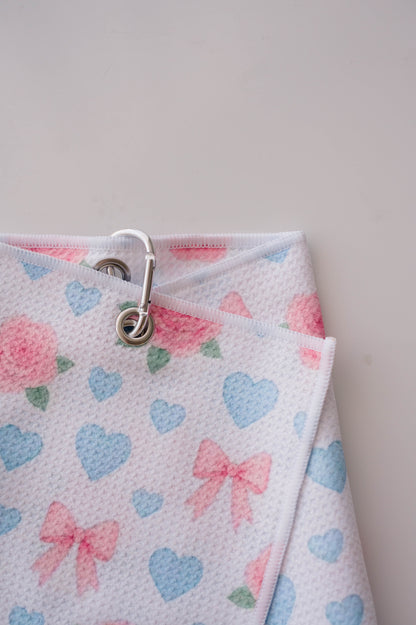 Snuggle Bug Golf Sweetheart Rose microfiber golf towel with pink roses, blue hearts, and bows with a silver hook.
