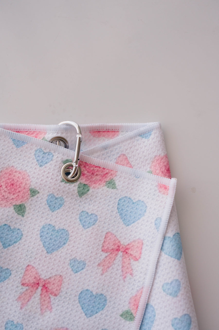 Snuggle Bug Golf Sweetheart Rose microfiber golf towel with pink roses, blue hearts, and bows with a silver hook.