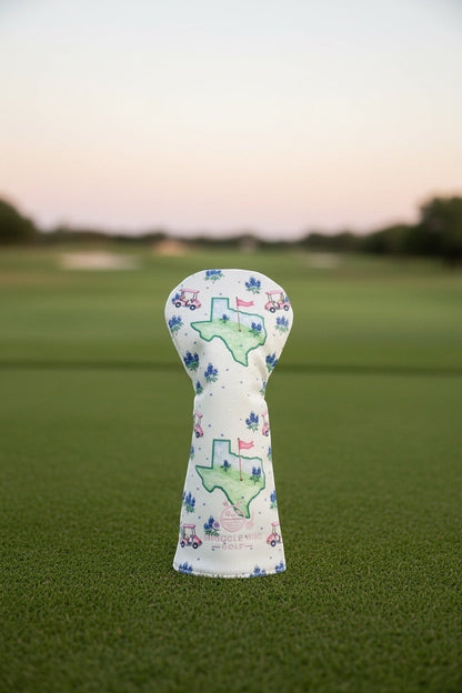 Snuggle Bug Golf Texas Bloom driver head cover in white eco-leather with bluebonnet and golf cart print on a golf course