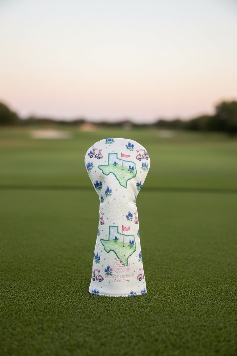 Snuggle Bug Golf Texas Bloom driver head cover in white eco-leather with bluebonnet and golf cart print on a golf course