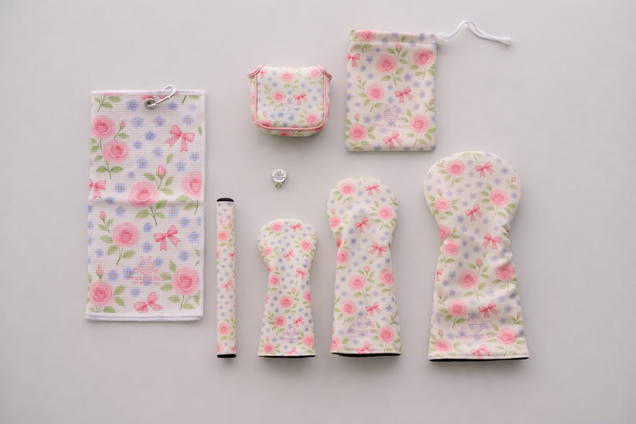 Snuggle Bug Golf Whisper Rose 8-piece golf accessory bundle with floral headcovers, towel, grip, and pouch.
