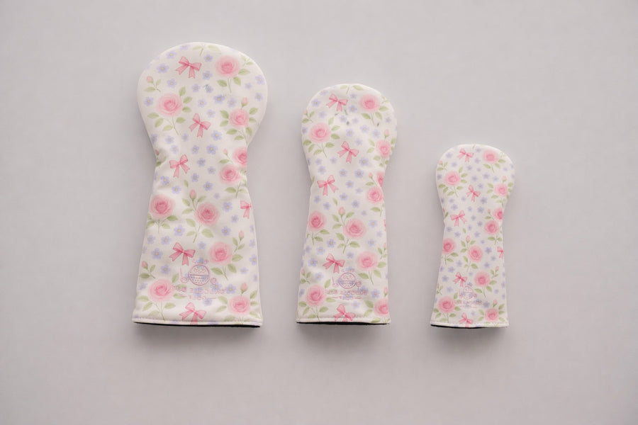 Snuggle Bug Golf Whisper Rose fairway headcovers in three sizes with floral print, pink bows, and pebbled eco-leather.