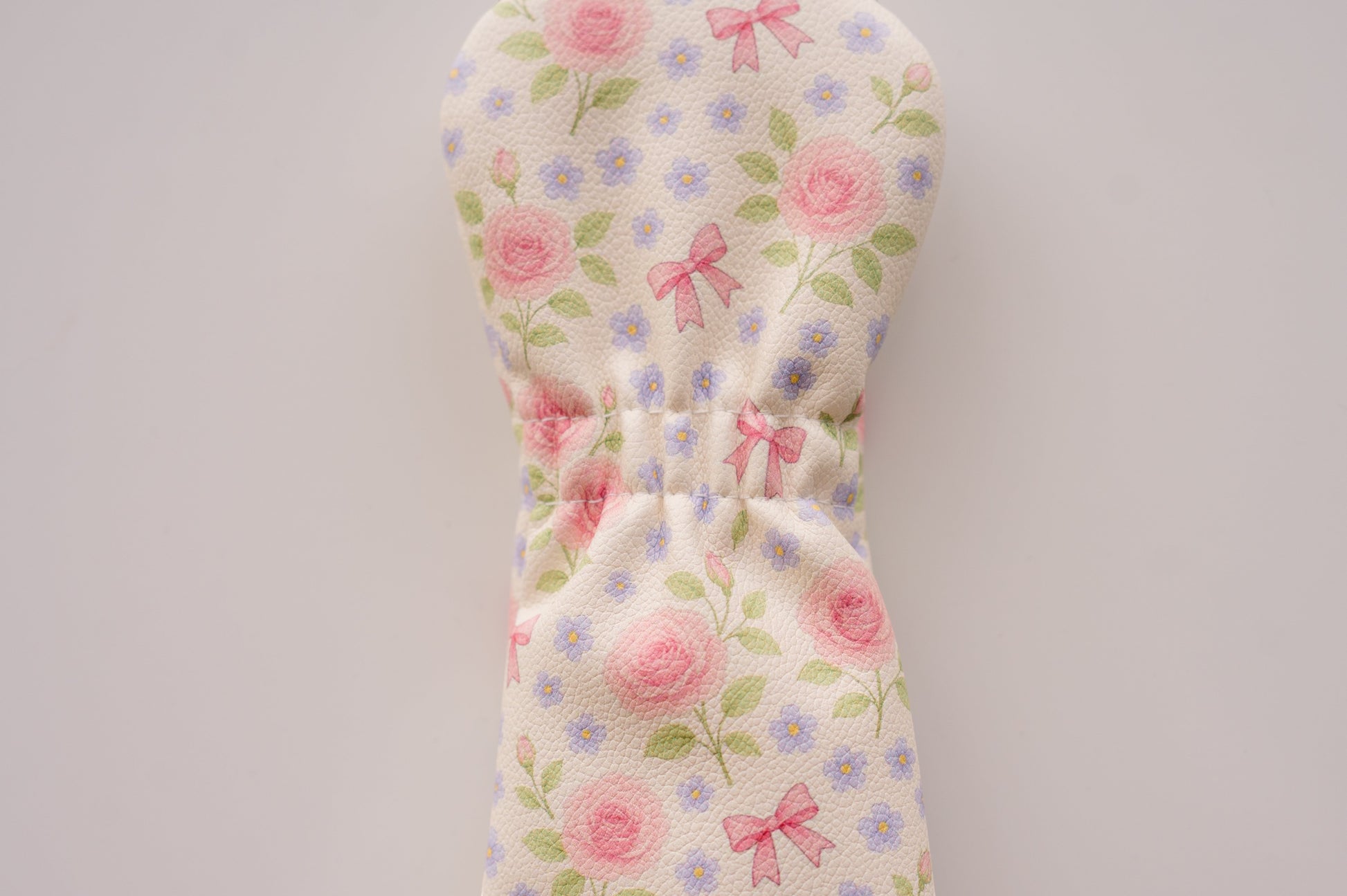 Snuggle Bug Golf Whisper Rose hybrid headcover with blush floral print, pink bows, and textured eco-leather finish.