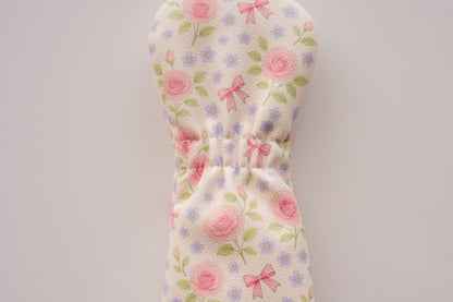 Snuggle Bug Golf Whisper Rose hybrid headcover with blush floral print, pink bows, and textured eco-leather finish.