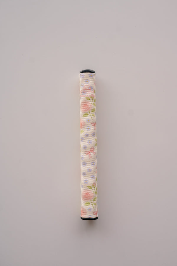 Snuggle Bug Golf Whisper Rose putter grip featuring a delicate floral print with pastel bows on a white EVA surface.