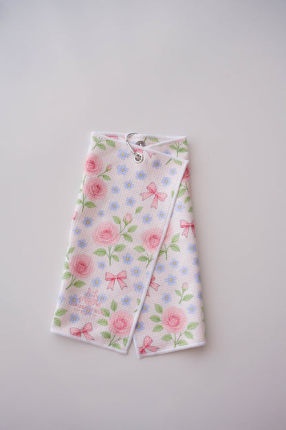 Snuggle Bug Golf Whisper Rose microfiber towel with pink roses, blue flowers, and bows, featuring a silver hook.