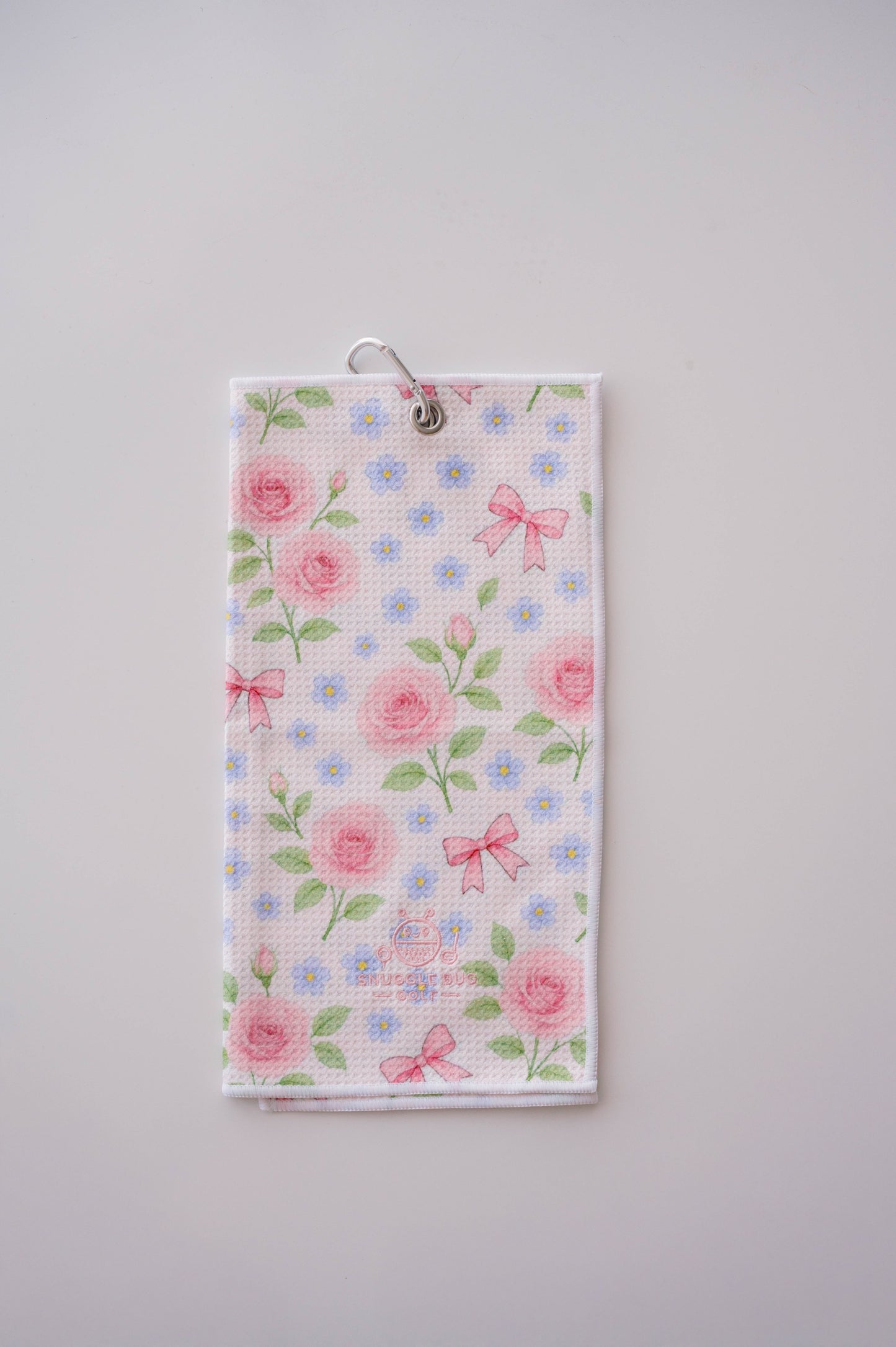 Snuggle Bug Golf Whisper Rose microfiber waffle towel with pink roses, blue flowers, and bows on a white background.