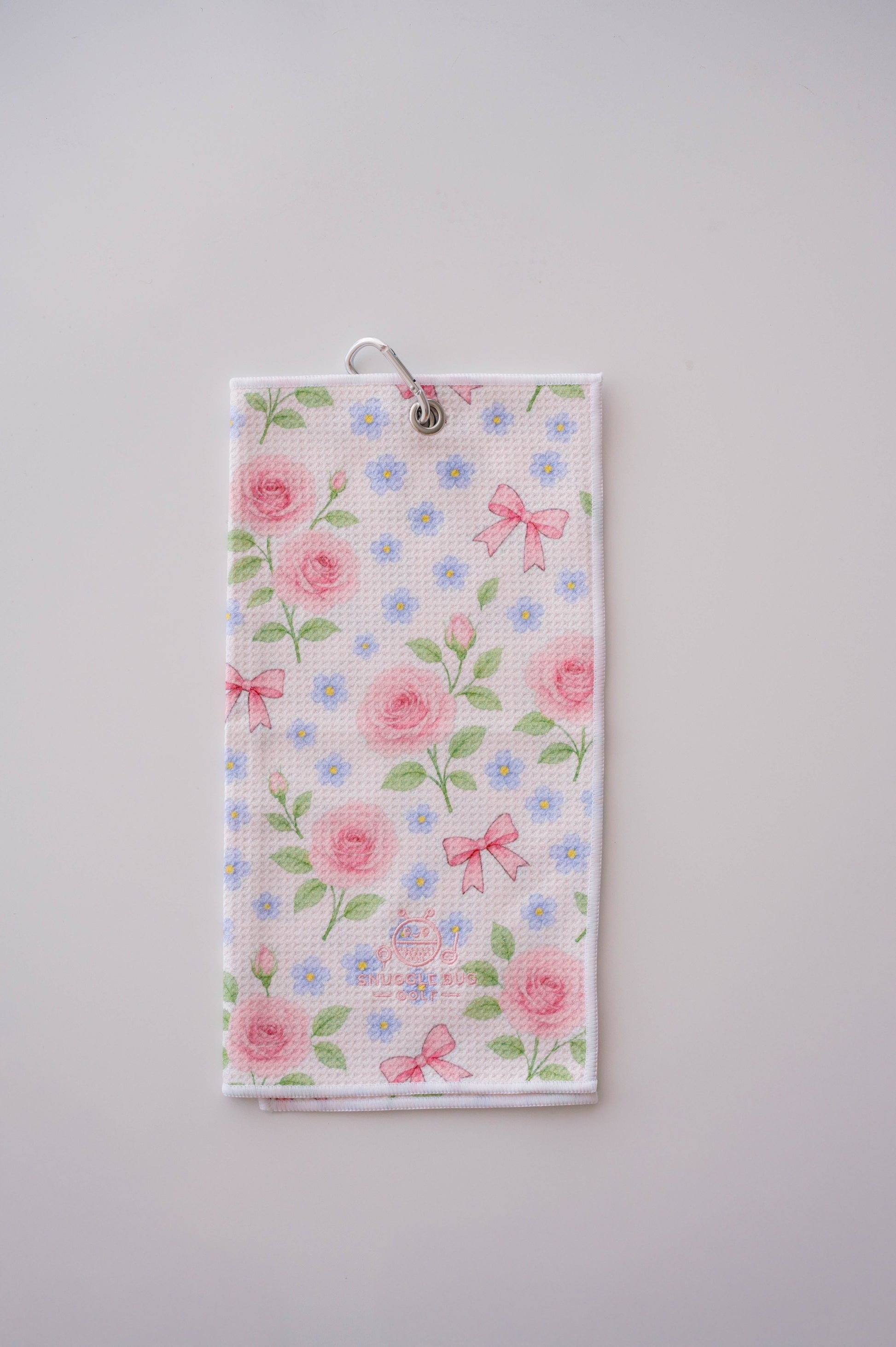 Snuggle Bug Golf Whisper Rose microfiber waffle towel with pink roses, blue flowers, and bows on a white background.