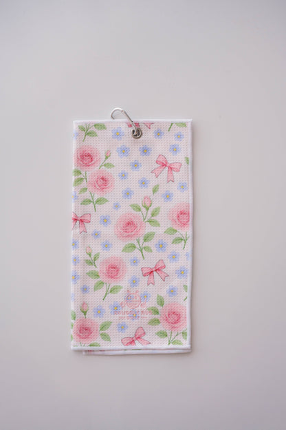 Snuggle Bug Golf Whisper Rose microfiber waffle towel with pink roses, blue flowers, and bows on a white background.