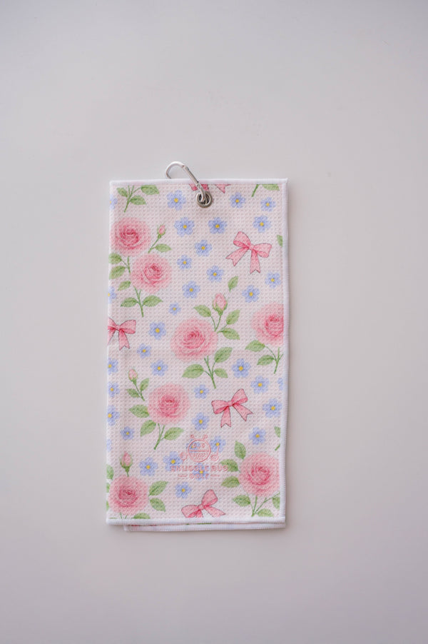 Snuggle Bug Golf Whisper Rose microfiber waffle towel with pink roses, blue flowers, and bows on a white background.