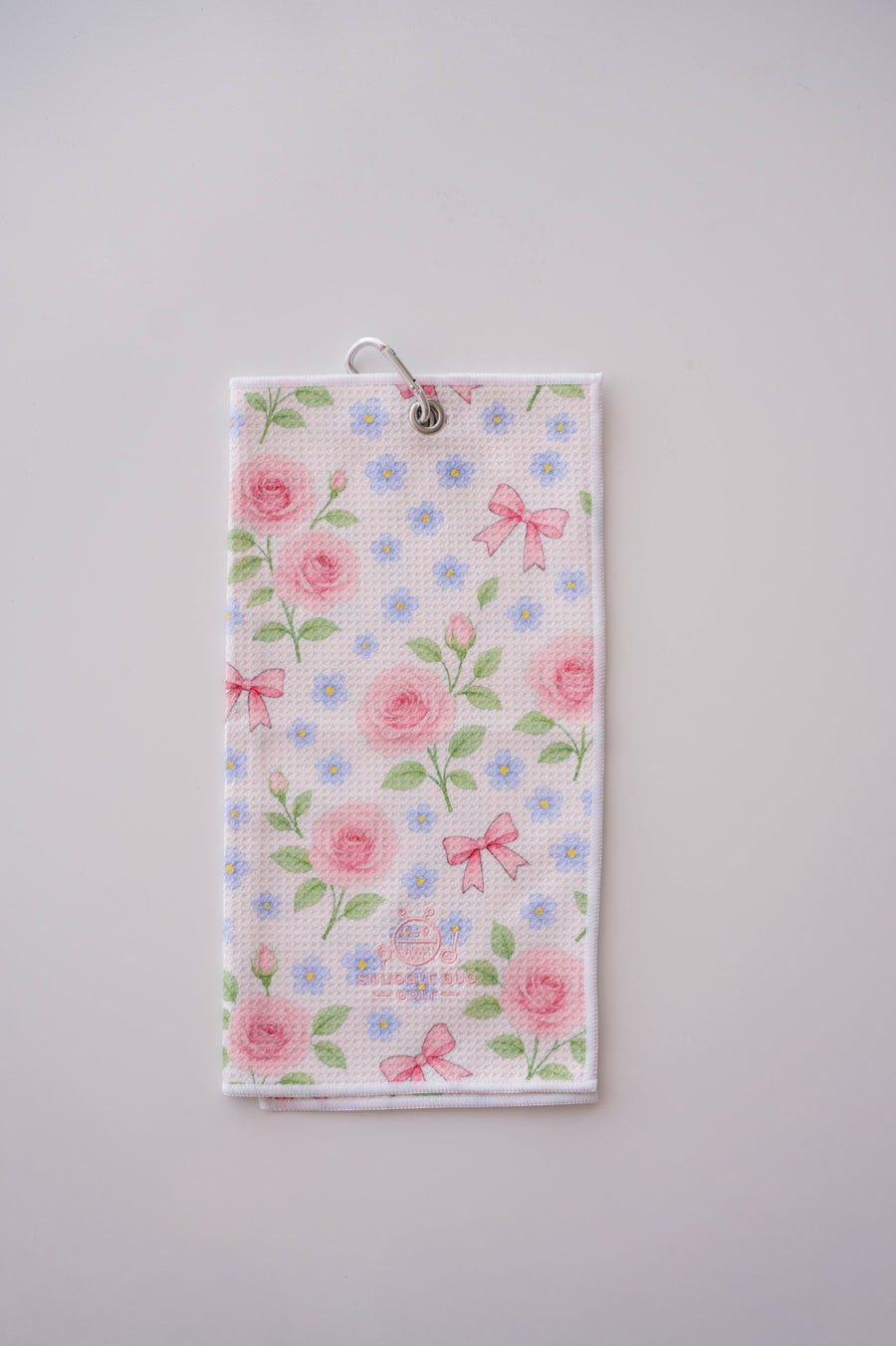 Snuggle Bug Golf Whisper Rose microfiber waffle towel with pink roses, blue flowers, and bows on a white background.